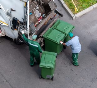 garbage men loading household rubbish in garbage truck, view from above garbage men loading household rubbish in garbage truck, view from above
